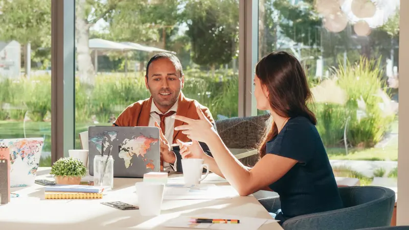 Two partners at a table, as shot