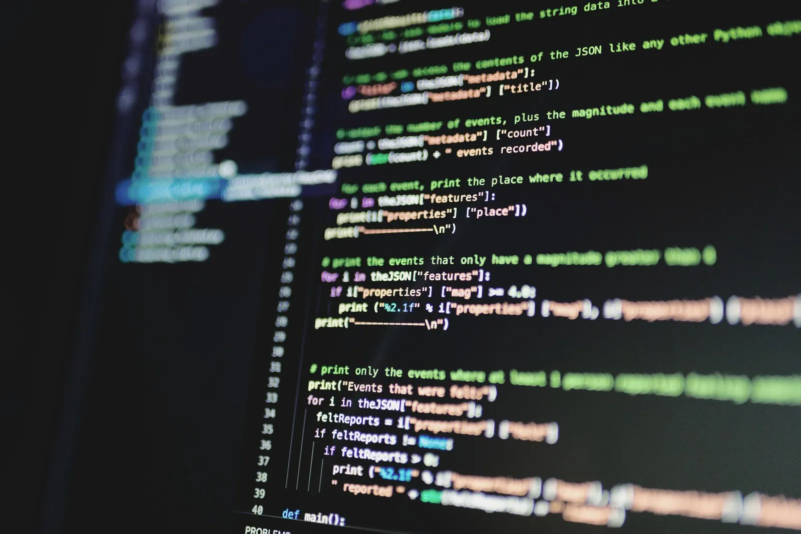 Close-up of code on a dark monitor, angled and softly out of focus at the edges.